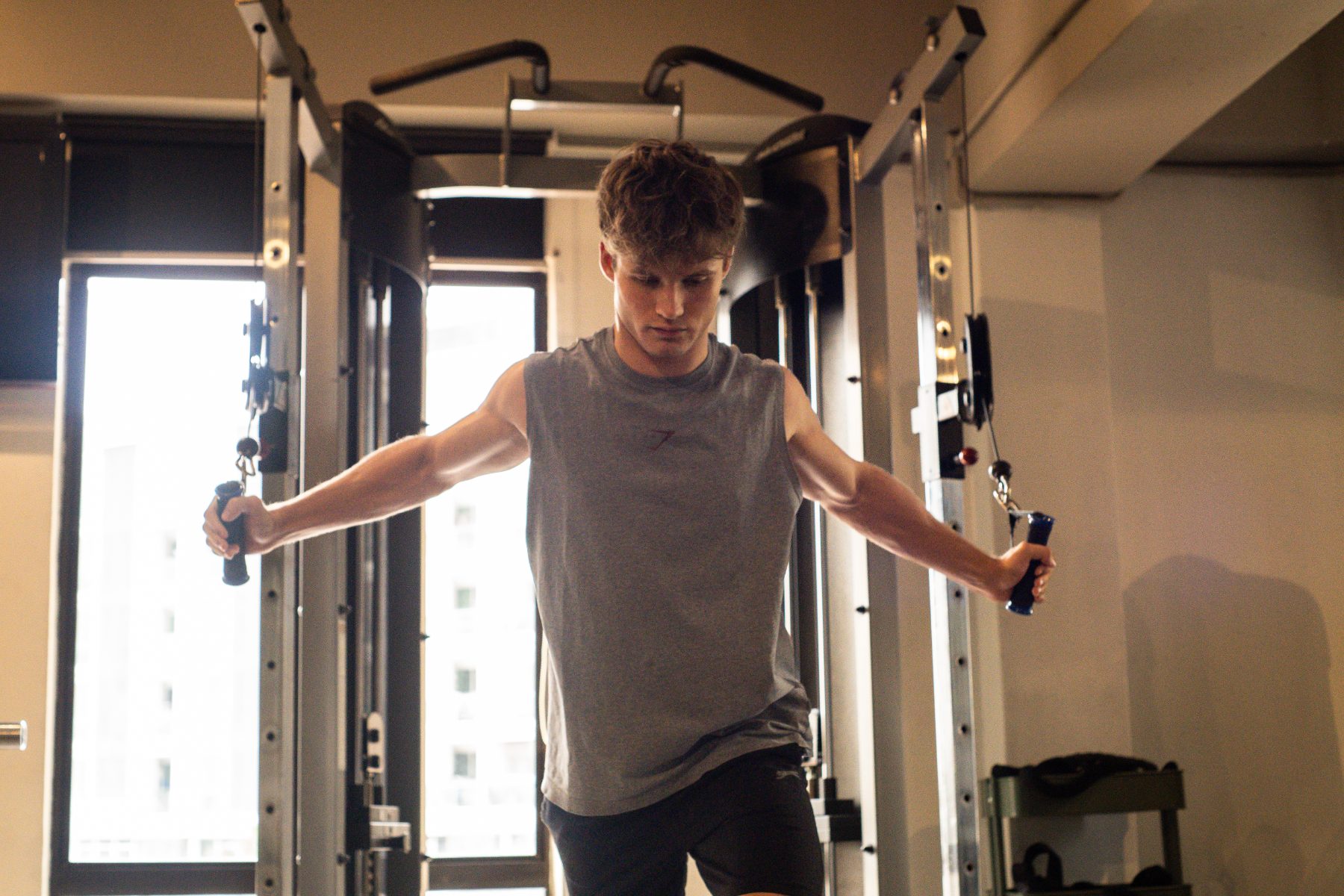 A member training on the cable machine on the Body for Life open gym floor
